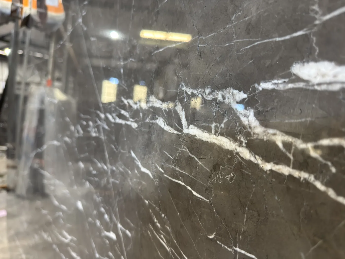 Charcoal-grey slab crossed by bright white veins